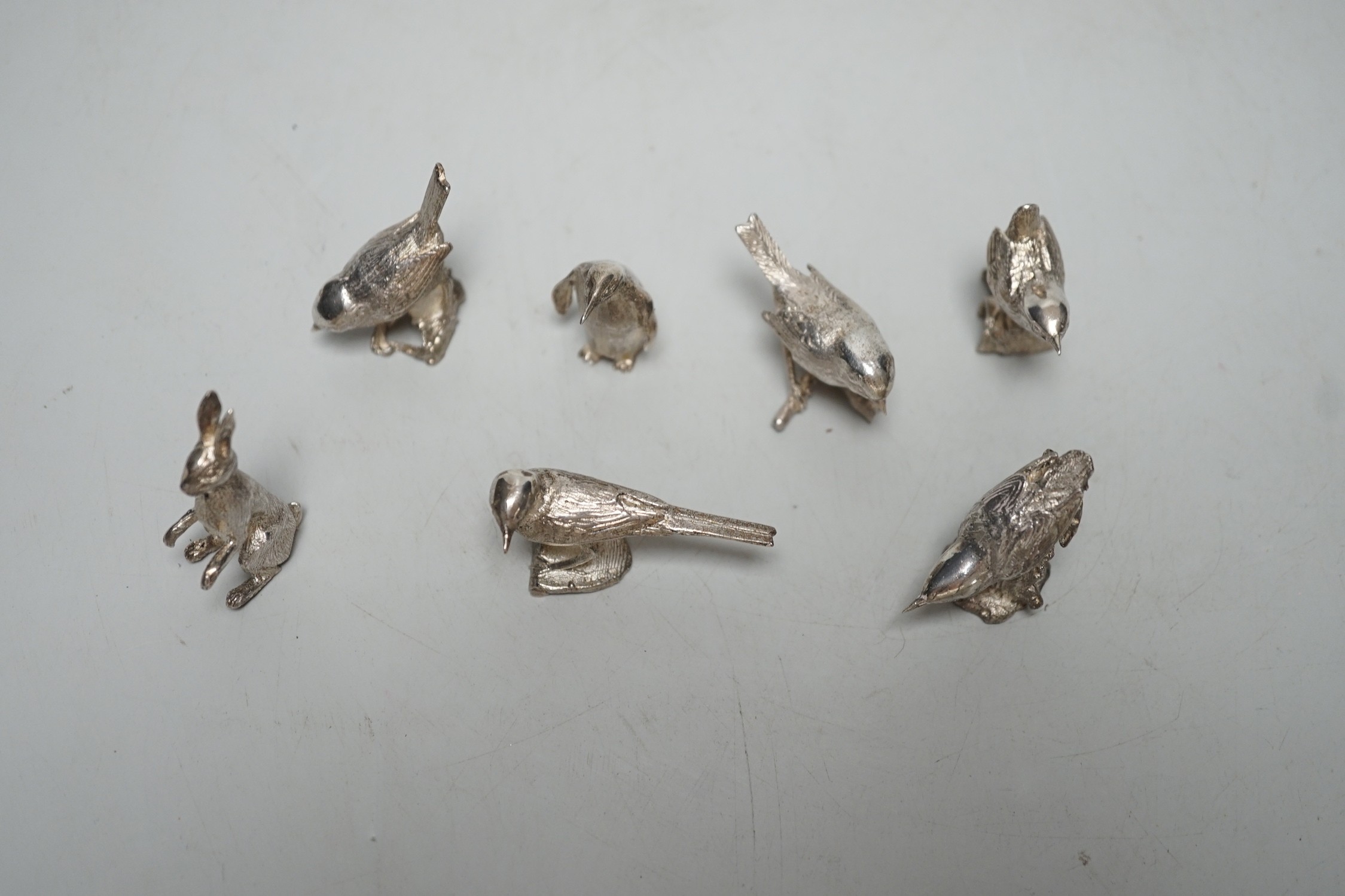 A small collection of seven 1980's/1990's miniature silver models, by Paul Eaton, comprising five birds, a rabbit and a penguin, tallest 43mm.